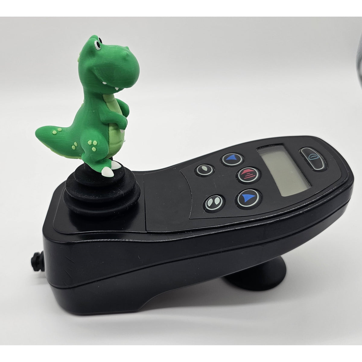 Cute dino joystick topper on an electric wheelchair controller