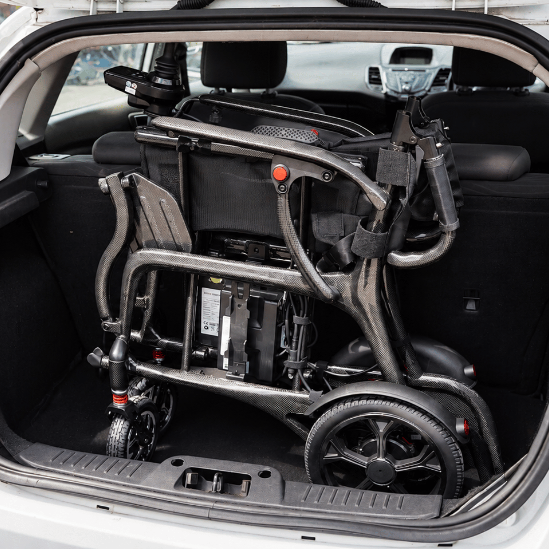 Evora Carbon lightweight folding electric wheelchair with 22cm folded width in small car boot by Etech Mobility