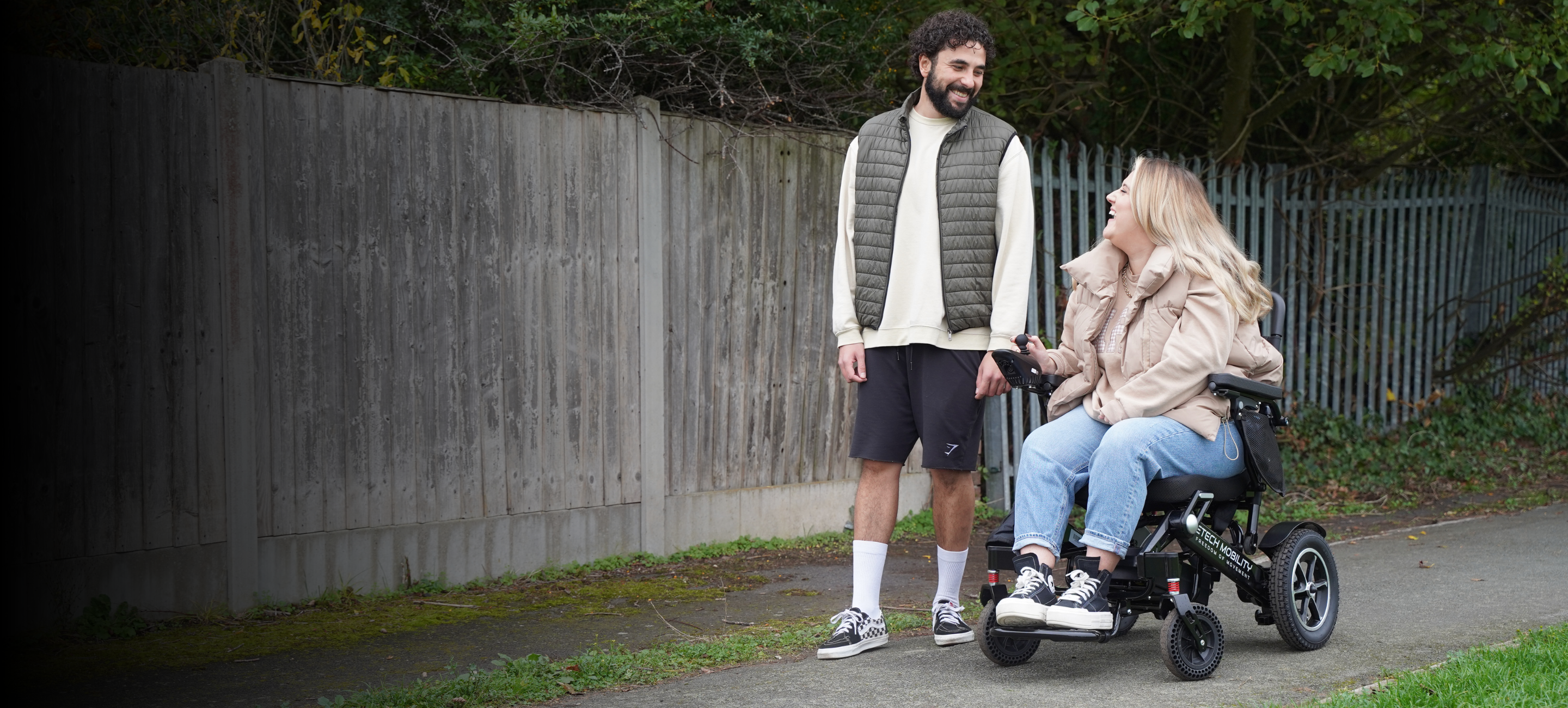 Etech Mobility folding lightweight electric wheelchair with carer and ambulatory user