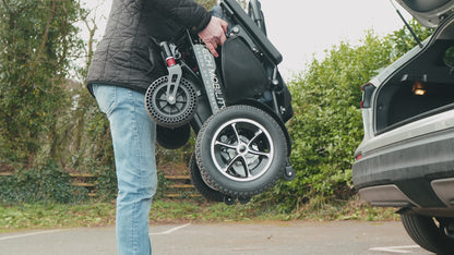 Freedom Pro ST lightweight foldable electric wheelchair used by ambulatory user