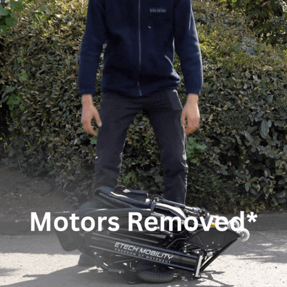 User lifting Y20 Luxe electric wheelchair with the motors removed.